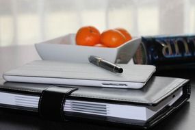 Ipad and address book are on a table