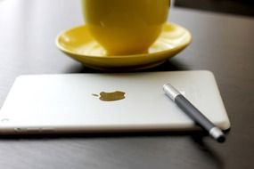 ipad and yellow cup