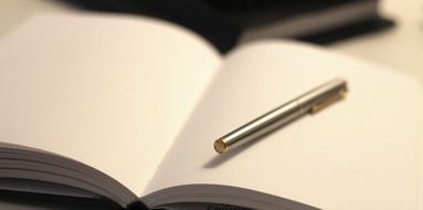 Close up photo of pen on a notebook