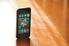 A touch screen mobile phone is on the table