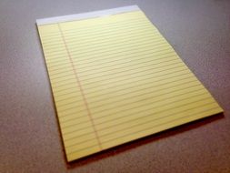 notepad with yellow paper