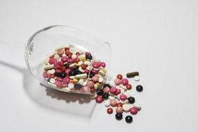 Colored tablets in an inverted glass