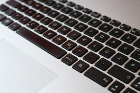 black keyboard of the white laptop