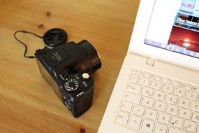 white laptop and a camera on the table