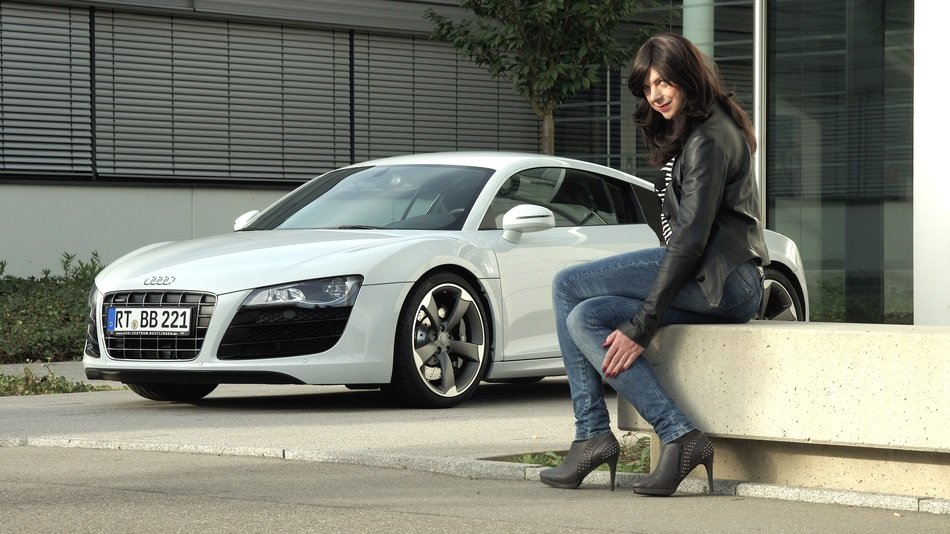 brunette on the background of a sports car Audi
