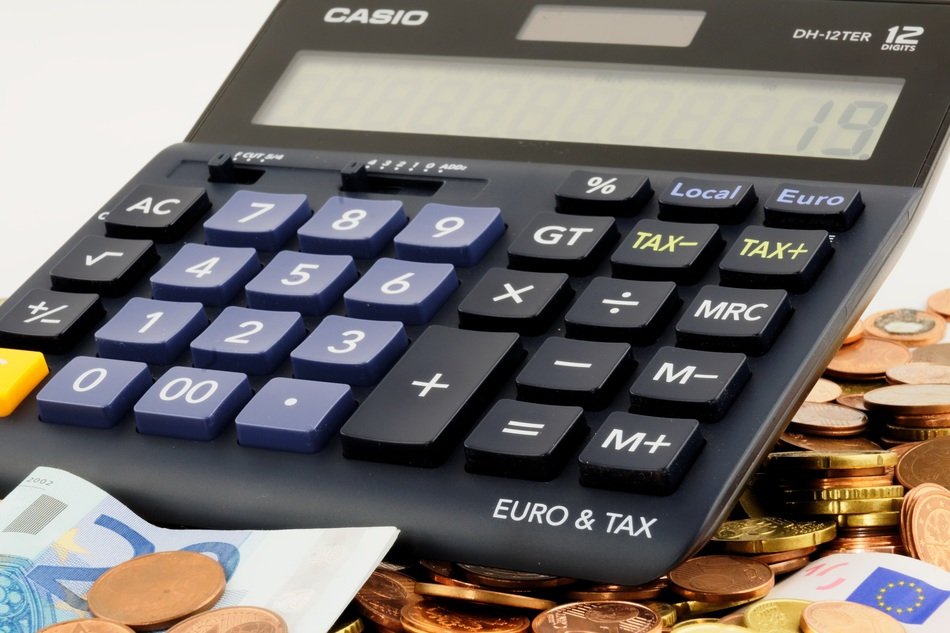 calculator on the background of the euro coins
