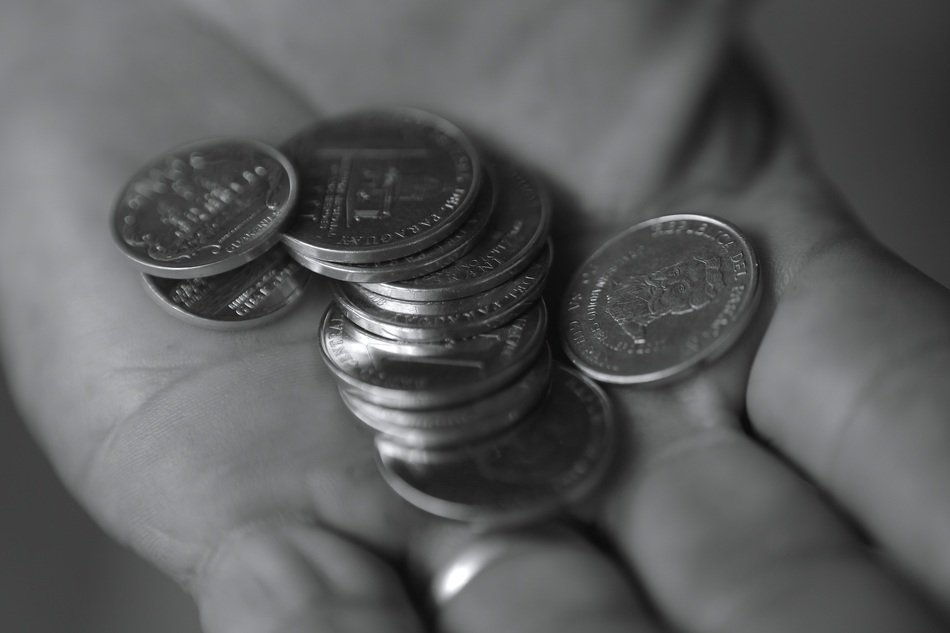 coins in hand in black and white image