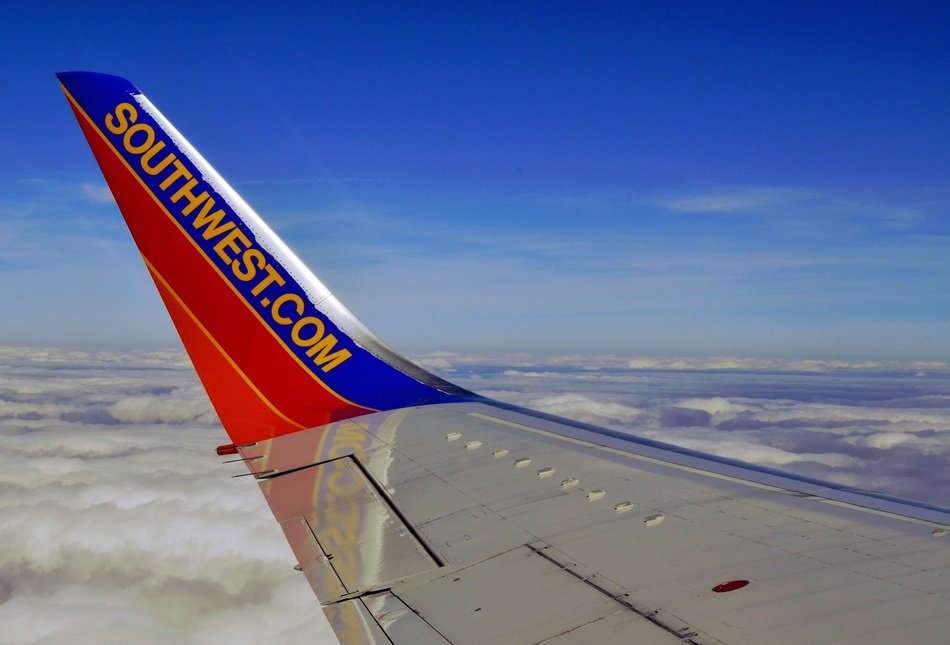 southwest script on plane’s wing above clouds