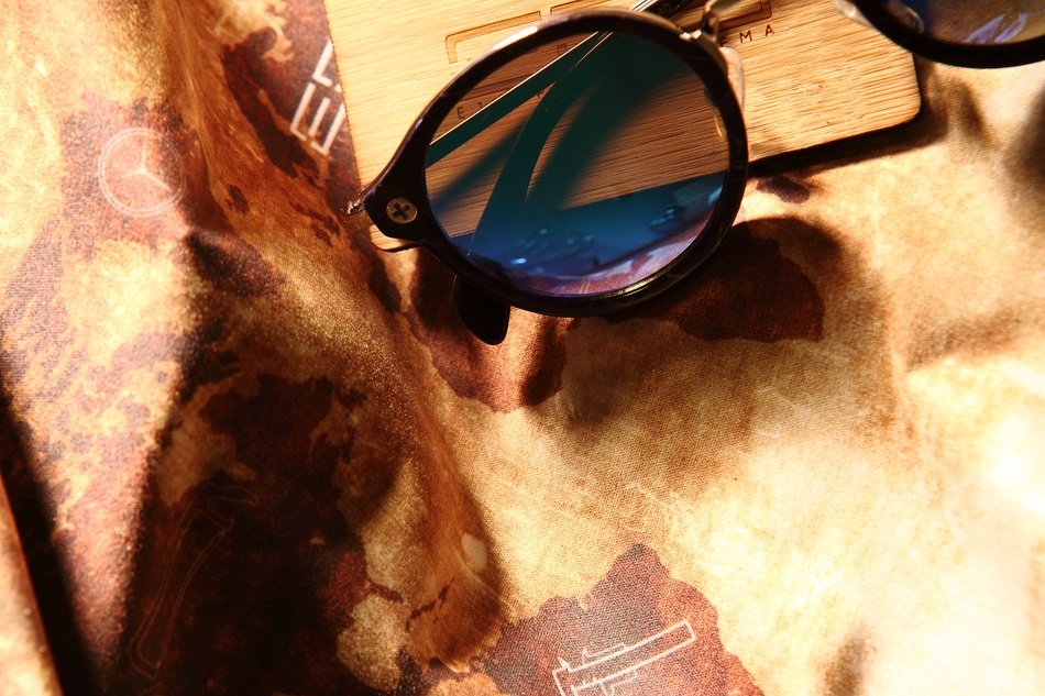 Sunglasses on a background map of the world