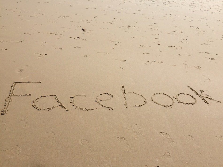 word faÑebook on the sand