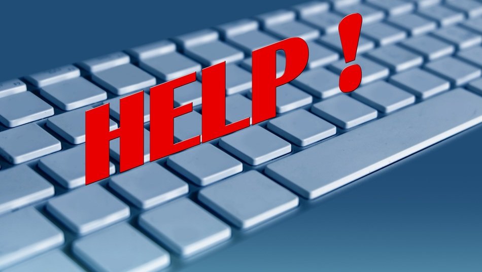empty computer keybord with the word help in red
