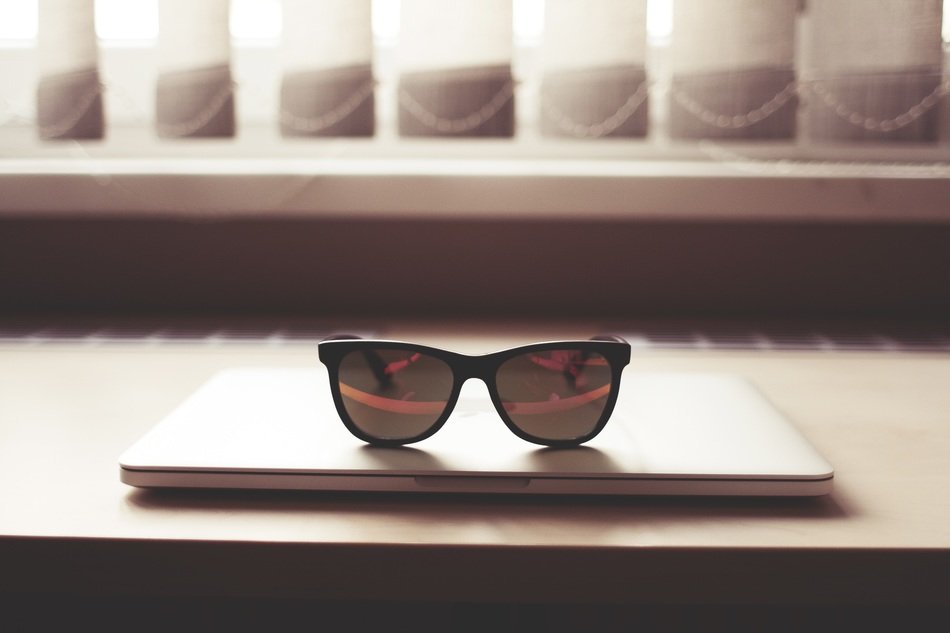 glasses on a macbook in an office