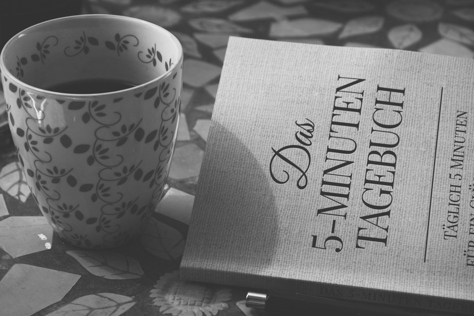 Black and white photo of book and tea