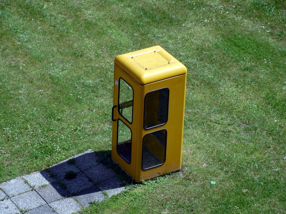 yellow telephone box on the lawn