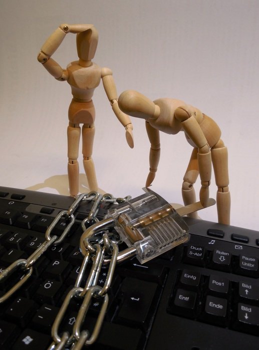 wooden men and a chain with a lock