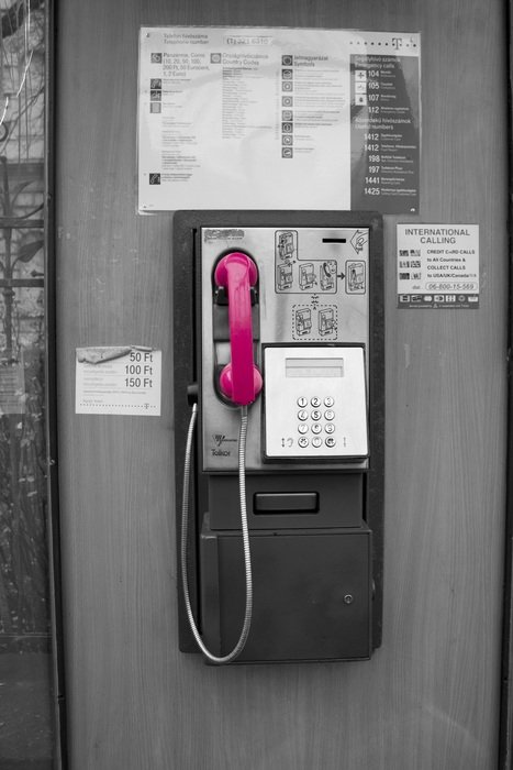 Pink telephone on a wall