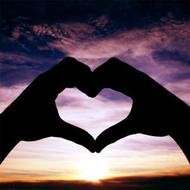 Heart Shaped Hands in front of colorful sunset sky, collage