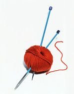 red Yarn and blue knitting Needles