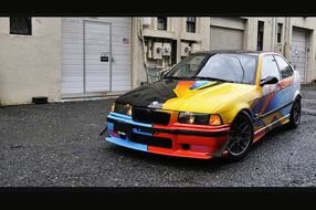 multi-colored BMW stands on the road