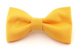 yellow bow tie on a white surface