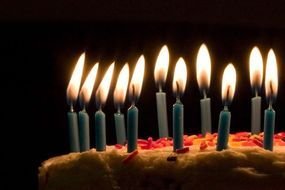 blue burning candles on a festive cake