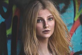 photo of a blonde on a background of a wall with graffiti