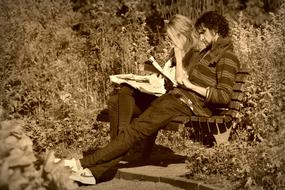 man and woman resting on a bench in monochrome