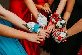 beautiful flowers on the hands of girls at the prom at school
