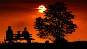 silhouette of Family on Bench at Sunset