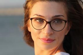 portrait of a woman with glasses on a blurred background