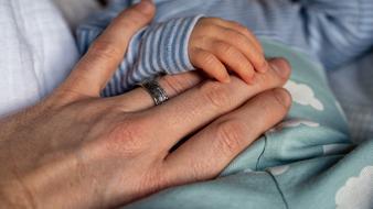 fatherâs hand and babyâs hand