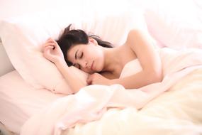 photo of a girl sleeping in bed