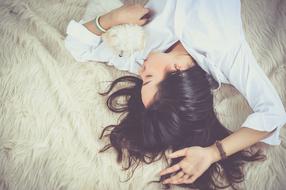young long haired Girl Sleeps on her back