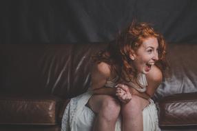 Young redhead woman laughing
