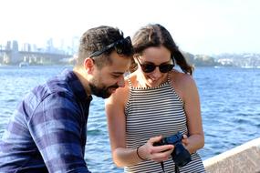 couple on the embankment discussing photographs