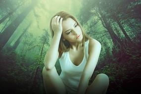young thoughtful Woman sits at misty forest