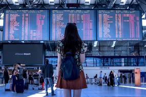 brunette looks nra schedule of airplanes at the airport