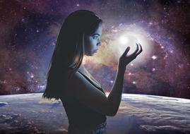 girl with a bright ball in her hand on a background of the galaxy