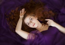 photo of red-haired girl in a purple dress