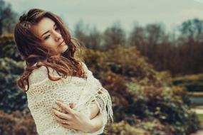 thoughtful Pretty Girl wearing white scarf outdoor, portrait