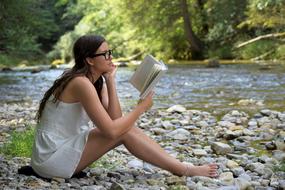 Picture of Girl is reading a book on a lake