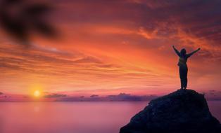woman at sunset as a symbol of freedom