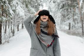 happy young Girl posing on path in snowy forest