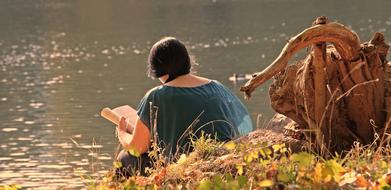 reading woman on the riverside