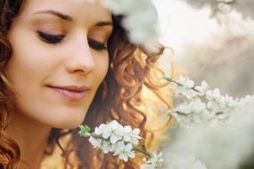 girl by a white flowering tree