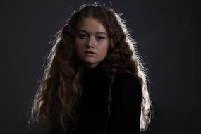 dark photo of a girl with long curly hair