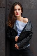 girl in leather jacket posing near the wall