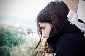 Girl teenager near the green forest