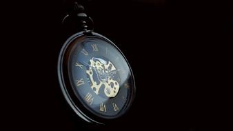 Pocket watch on the black background