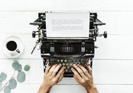 male hands on keys of vintage typewriter